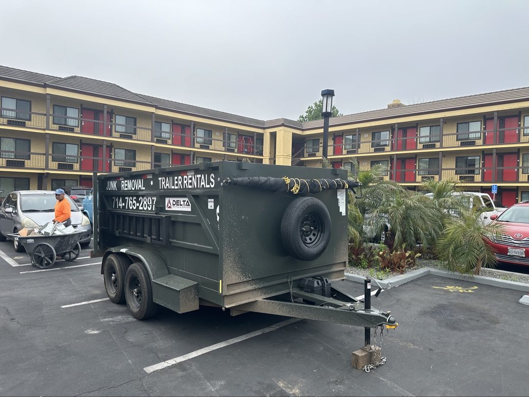 Delta trailer rental with Junk Removal and Trailer Rentals branding on the side