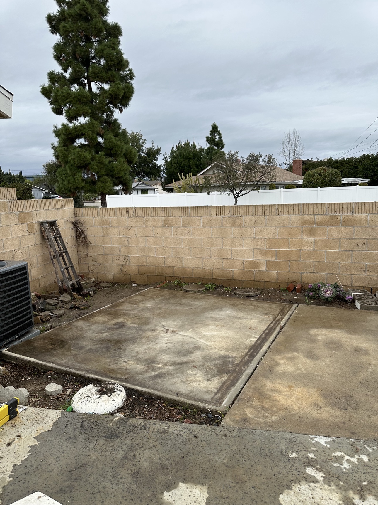 Cleared concrete pad after a real Delta property cleanup in Fullerton