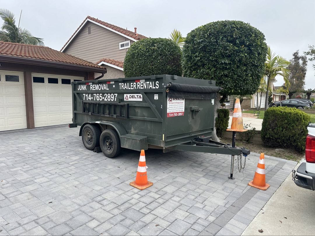 Delta dump trailer dropped in a Laguna Hills, California driveway with safety cones