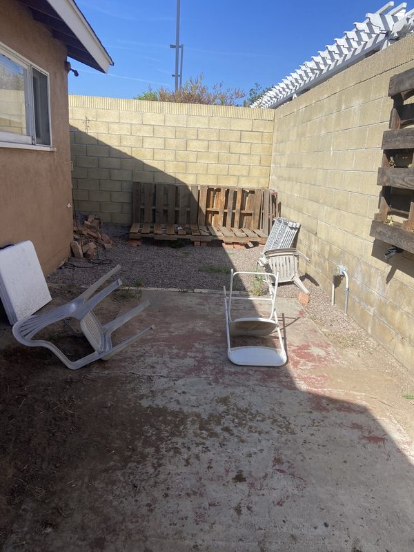 Side yard junk removal — Before